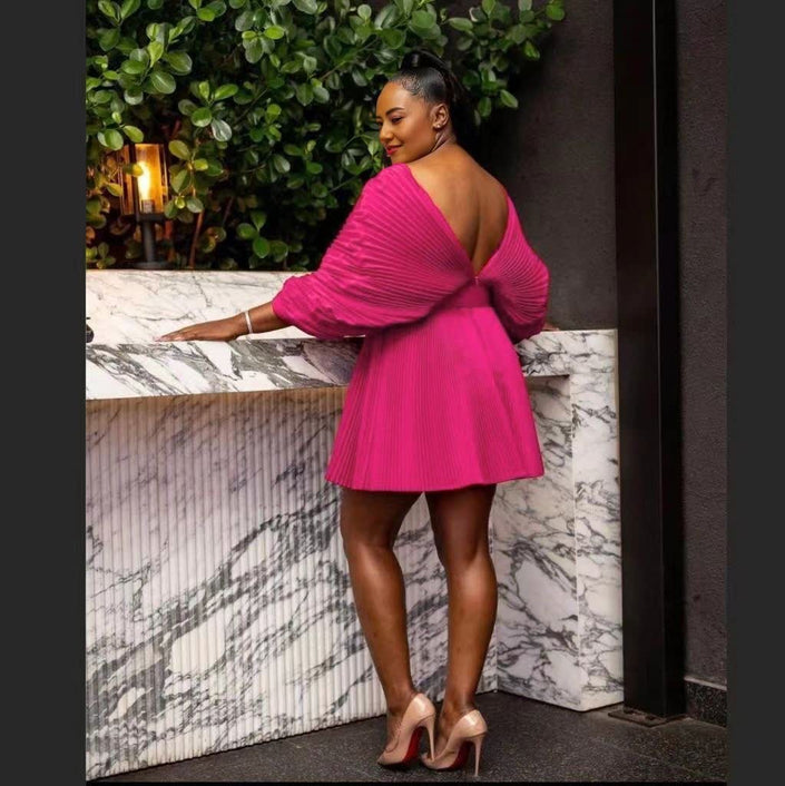 Pleated mini dress with deep V-back and short puff sleeves, hot pink.