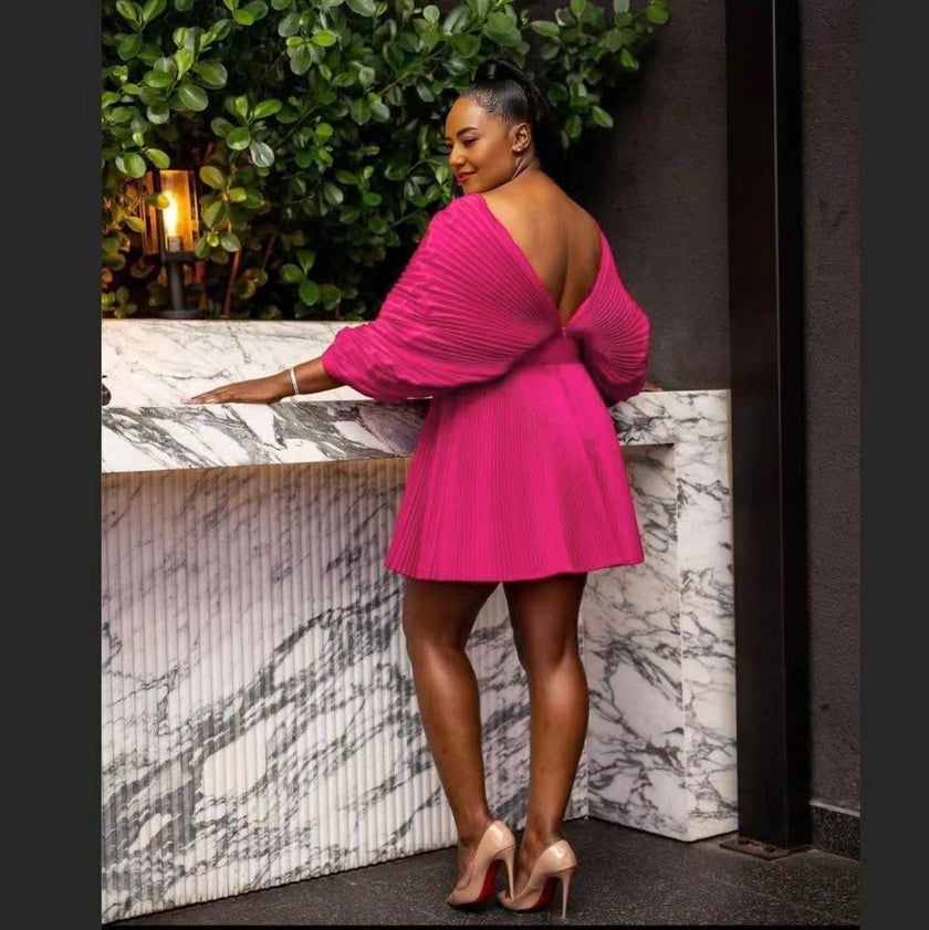 Pleated mini dress with deep V-back and short puff sleeves, hot pink.