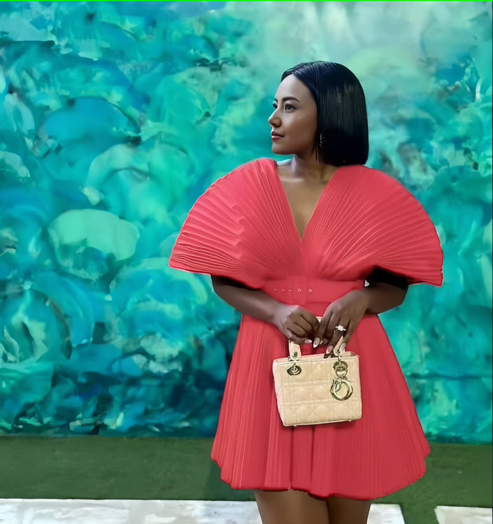 Pleated mini dress with V-neck and pleated puff sleeves, coral pink.