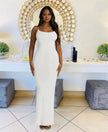 White sleeveless maxi dress with straight neckline, fitted silhouette to the floor.