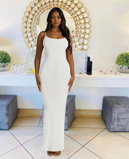 White sleeveless maxi dress with straight neckline, fitted silhouette to the floor.