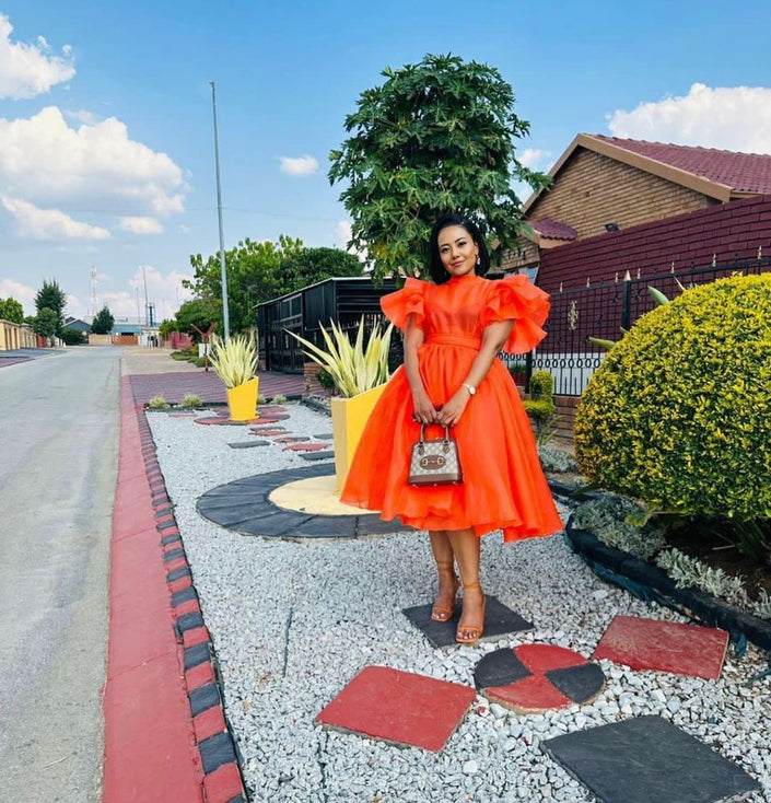 Orange-red puff-sleeve midi dress with flared skirt and gathered bodice