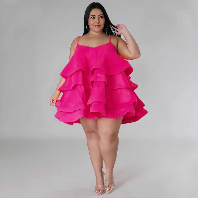 Fuchsia tiered ruffle mini dress with adjustable spaghetti straps and layered skirt.