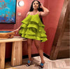 Green tiered ruffle mini dress with adjustable spaghetti straps and layered skirt.