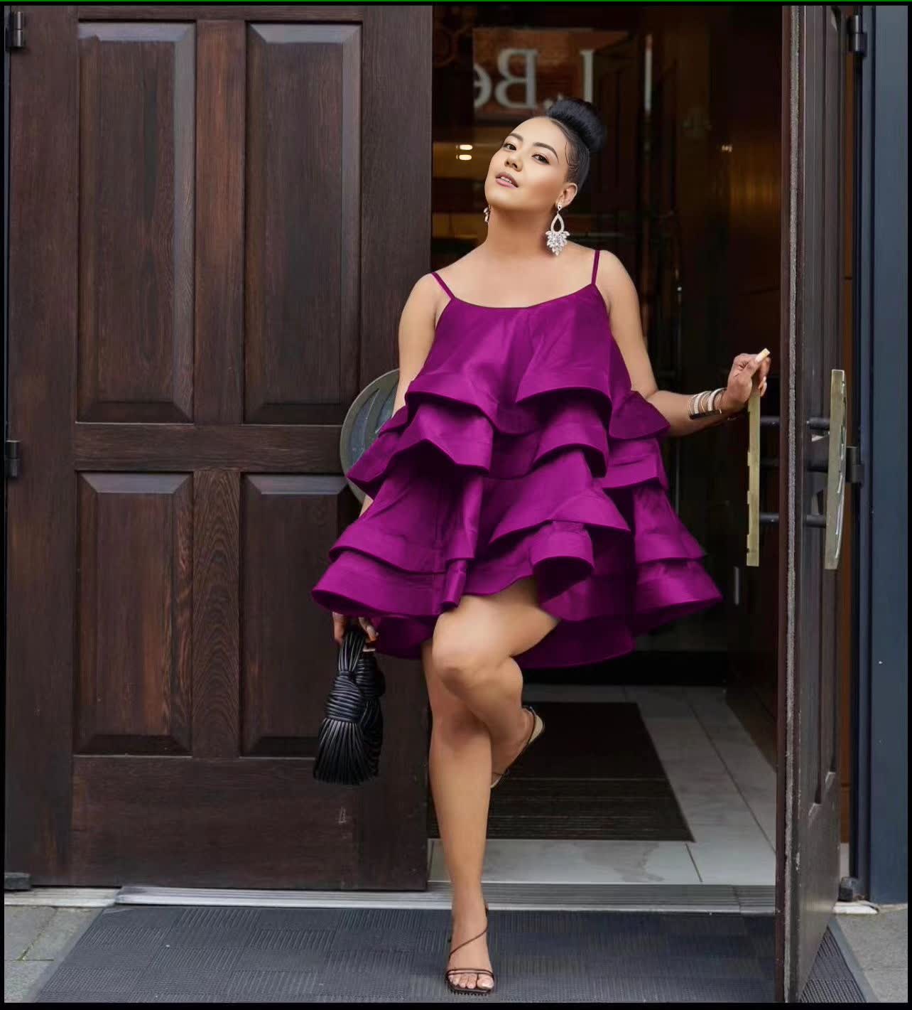 Purple tiered ruffle mini dress with adjustable spaghetti straps and layered ruffle skirt.