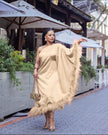 One-shoulder evening dress in beige satin, with feather trim at hem.
