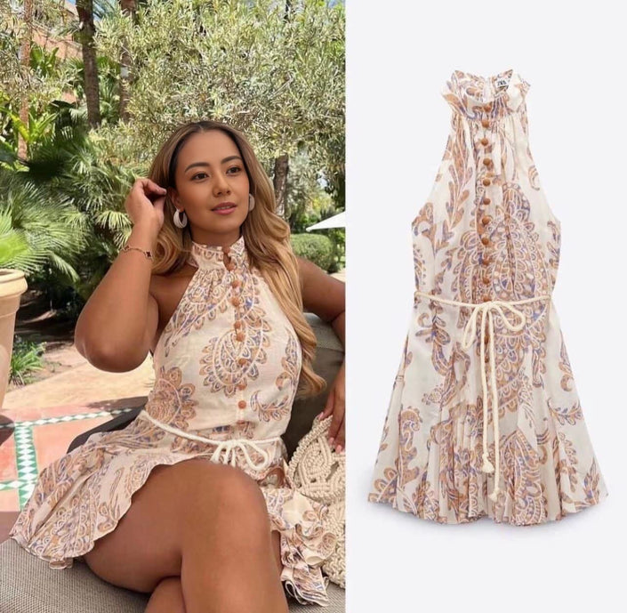 Printed halter mini dress with flare skirt, cream base and brown paisley pattern
