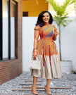 Knee-Length Pleated Dress with Embellished Neckline and Patterned Bodice