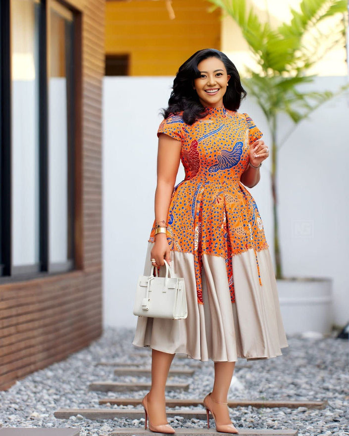 Pleated midi dress with embellished neckline, orange patterned top and full skirt