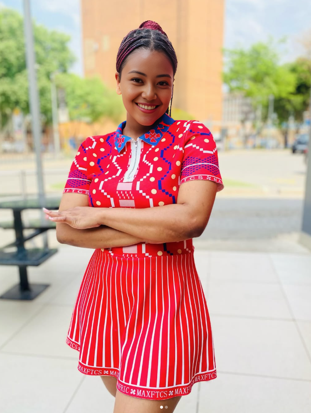 Geometric striped dress with red vertical stripes, white shapes, and short sleeves