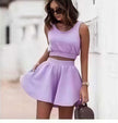 Lavender sleeveless cropped top and pleated mini skirt set with elastic waist