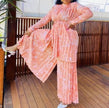 Peach pleated twin set with belted tunic and wide-leg pants, long sleeves