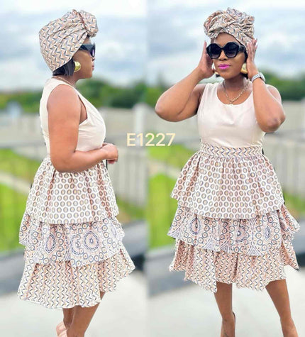 Sleeveless circular motif mini dress with tiered ruffle skirt, cream base