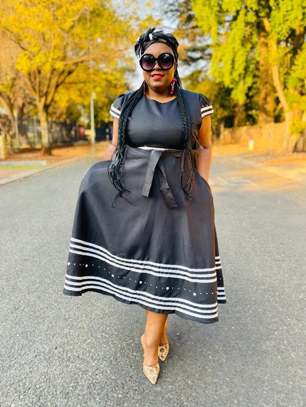 Black midi dress with ruffle sleeves, striped hem and full skirt