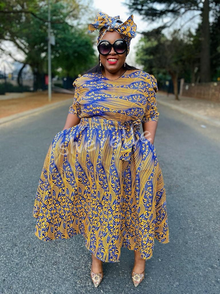Blue-and-yellow patterned flared midi dress with puff sleeves and gathered waist