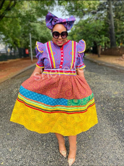 Multicolor layered skirt dress with puff sleeves, tiered ruffles, and bow