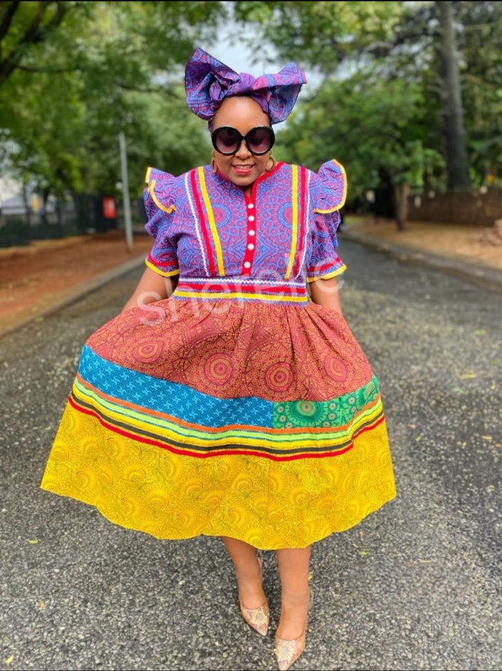 Multicolor layered skirt dress with puff sleeves, tiered ruffles, and bow