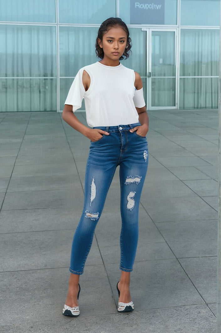 Women’s skinny distressed slim-fit jeans, blue wash with ripped knees and light fade