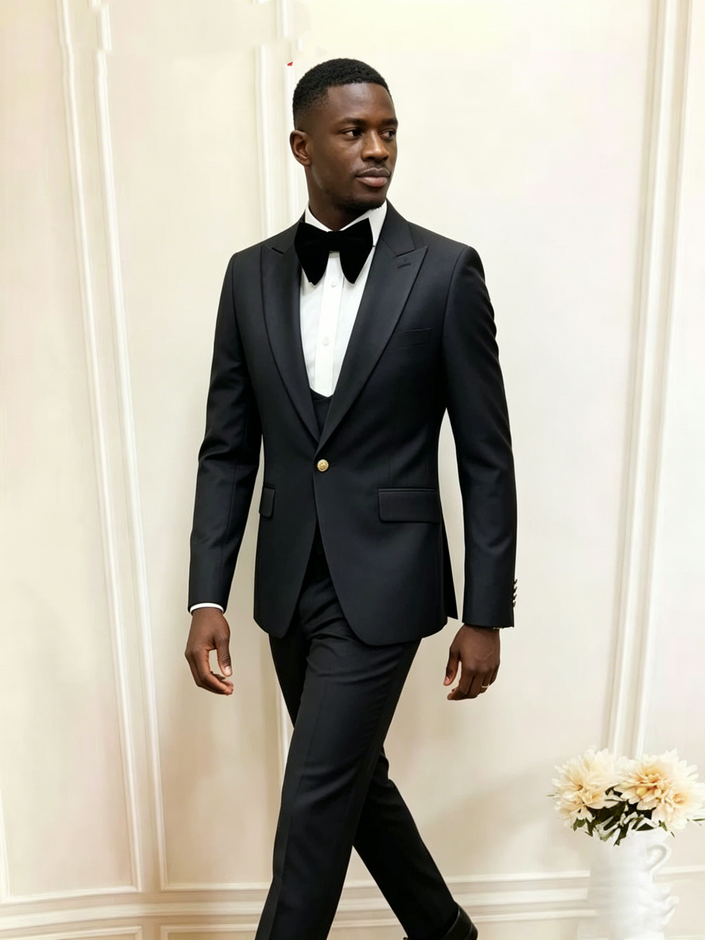 Mens slim-fit black tuxedo suit with satin bow tie, vest, and dress trousers
