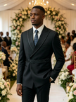 Black tuxedo suit jacket with satin peak lapels and patterned tie over white shirt