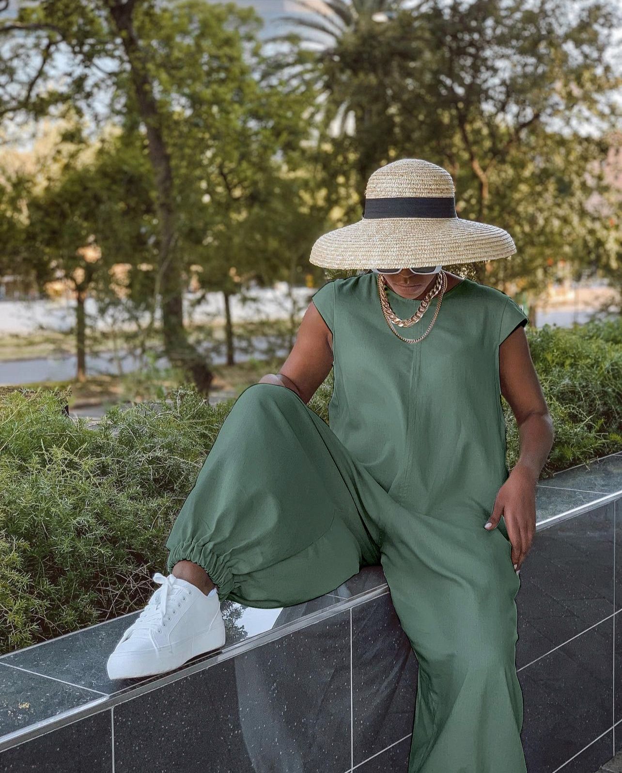 Olive green crew-neck wide-leg jumpsuit with loose fit and wide legs.