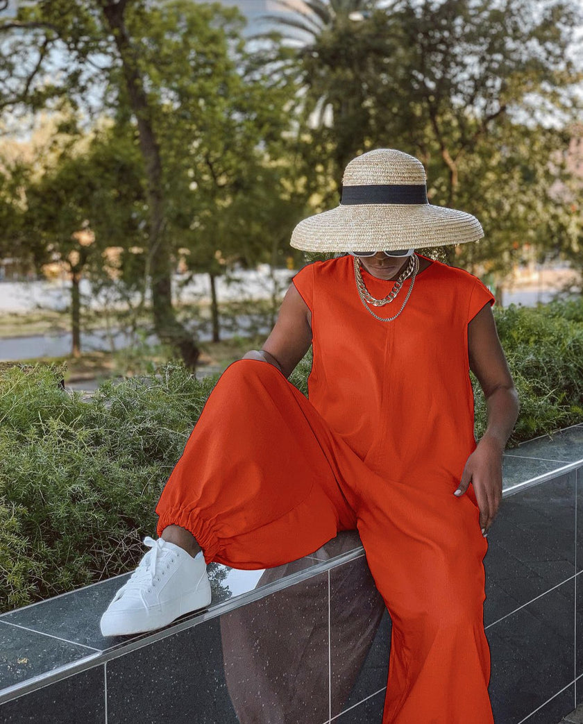 Orange crew-neck wide-leg jumpsuit with relaxed, roomy legs.