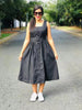 Black sleeveless midi dress with belted waist and button front