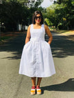 White sleeveless midi dress with belted waist and button front