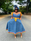 Blue midi dress with tie-accent puff sleeves, square neckline, patterned skirt border