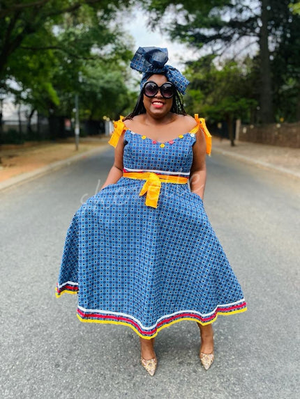 Blue midi dress with tie-accent puff sleeves, square neckline, patterned skirt border