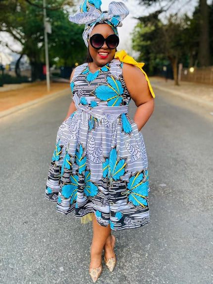 Pleated floral midi dress with blue and teal print, sleeveless, fitted waist