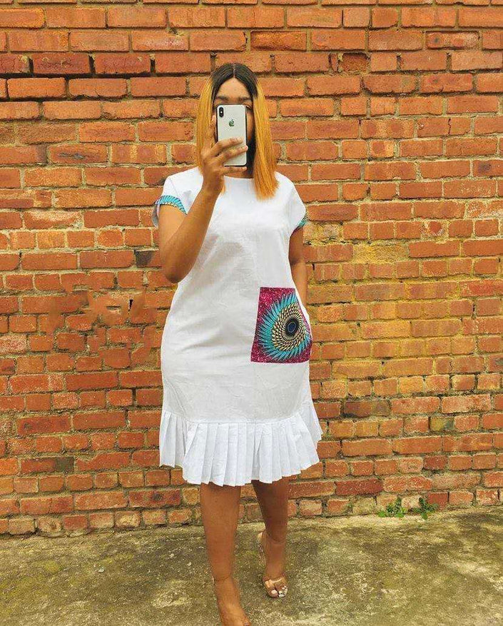White pleated hem dress with short sleeves and colorful side pocket