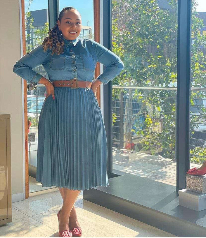 Dark blue denim midi dress with pleated high-waist skirt, button front, long sleeves.