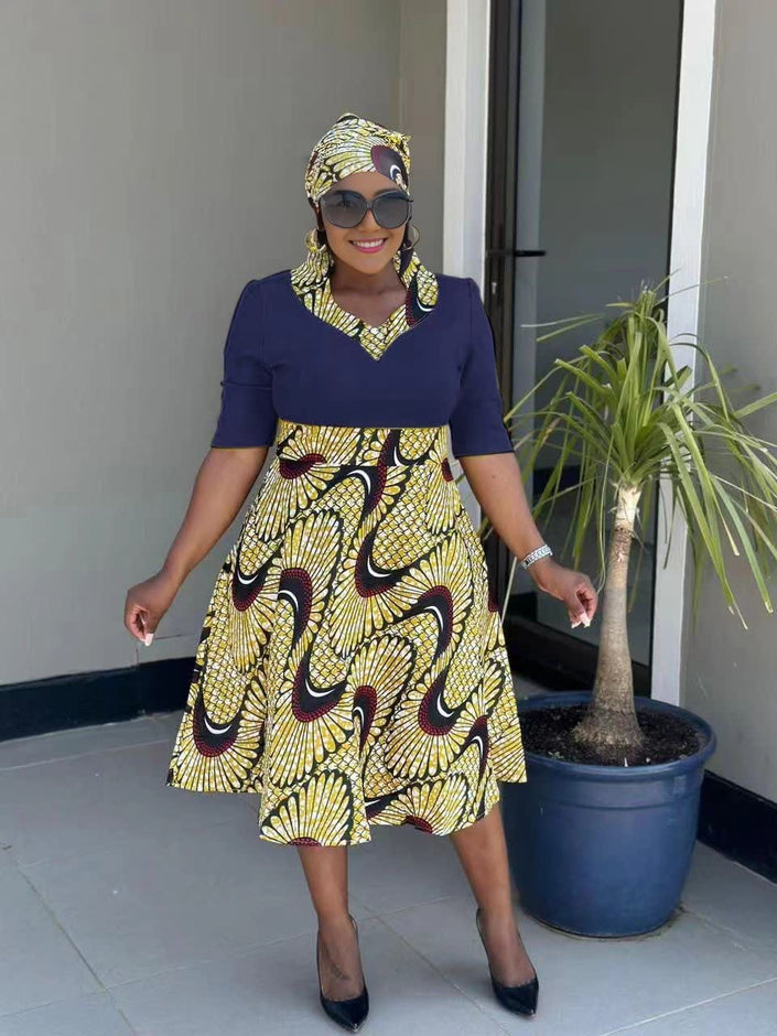 Pleated African print midi dress with navy top and flared patterned skirt, short sleeves, V-neck