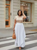 White pleated maxi skirt with asymmetrical layered hem