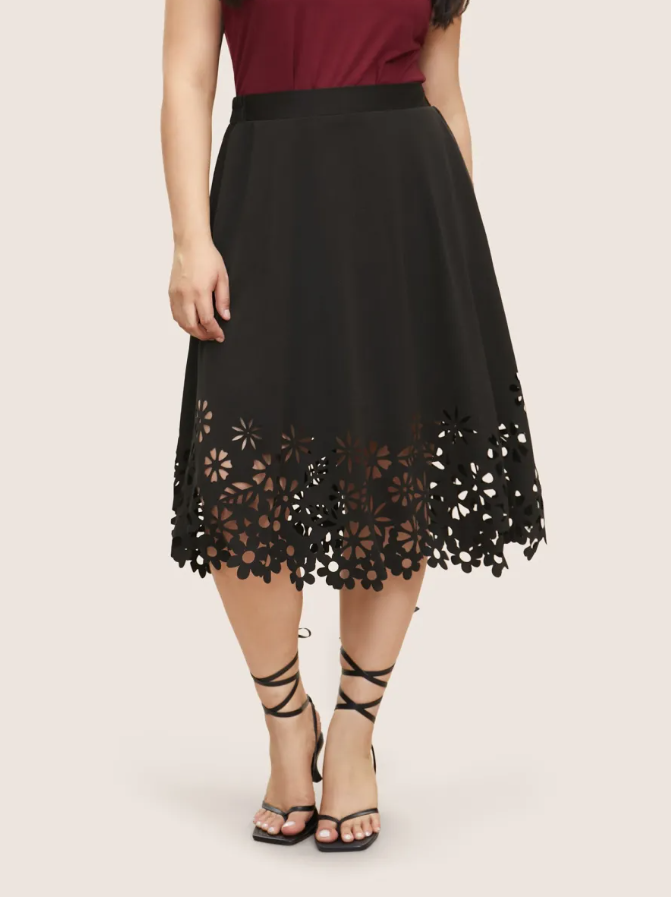 High-waist midi skirt in black with scalloped lace hem and starburst floral cutout trim
