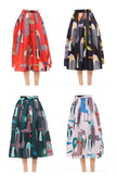 Pleated midi skirt with printed bird pattern in red, green, and blue