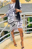 Newspaper print dress, white with black text, short sleeves, above-knee hem
