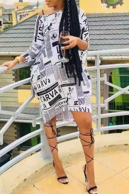 Newspaper print dress, white with black text, short sleeves, above-knee hem