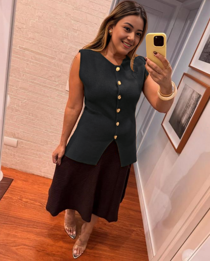 Black sleeveless top with gold buttons and side slit detail