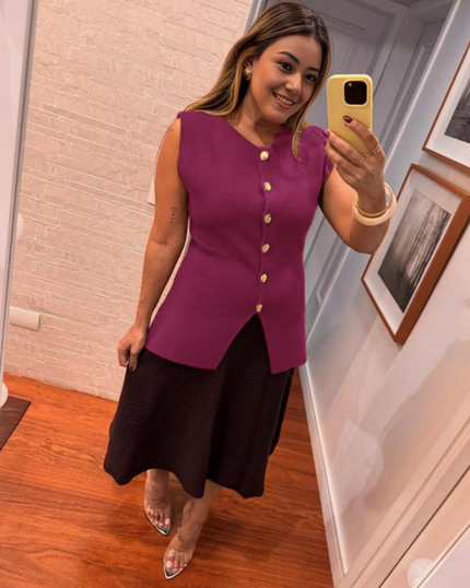 Maroon sleeveless top with gold buttons and side slit detail