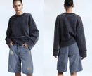 Distressed knee-length denim shorts, loose fit, light blue wash with rips
