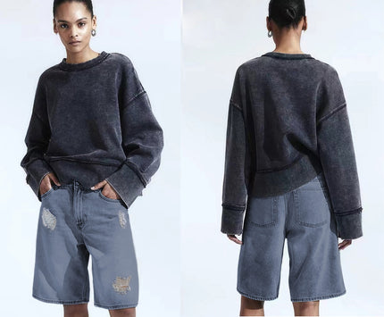 Distressed knee-length denim shorts, loose fit, light blue wash with rips