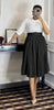 Black pleated midi A-line skirt with wide belt waistband.