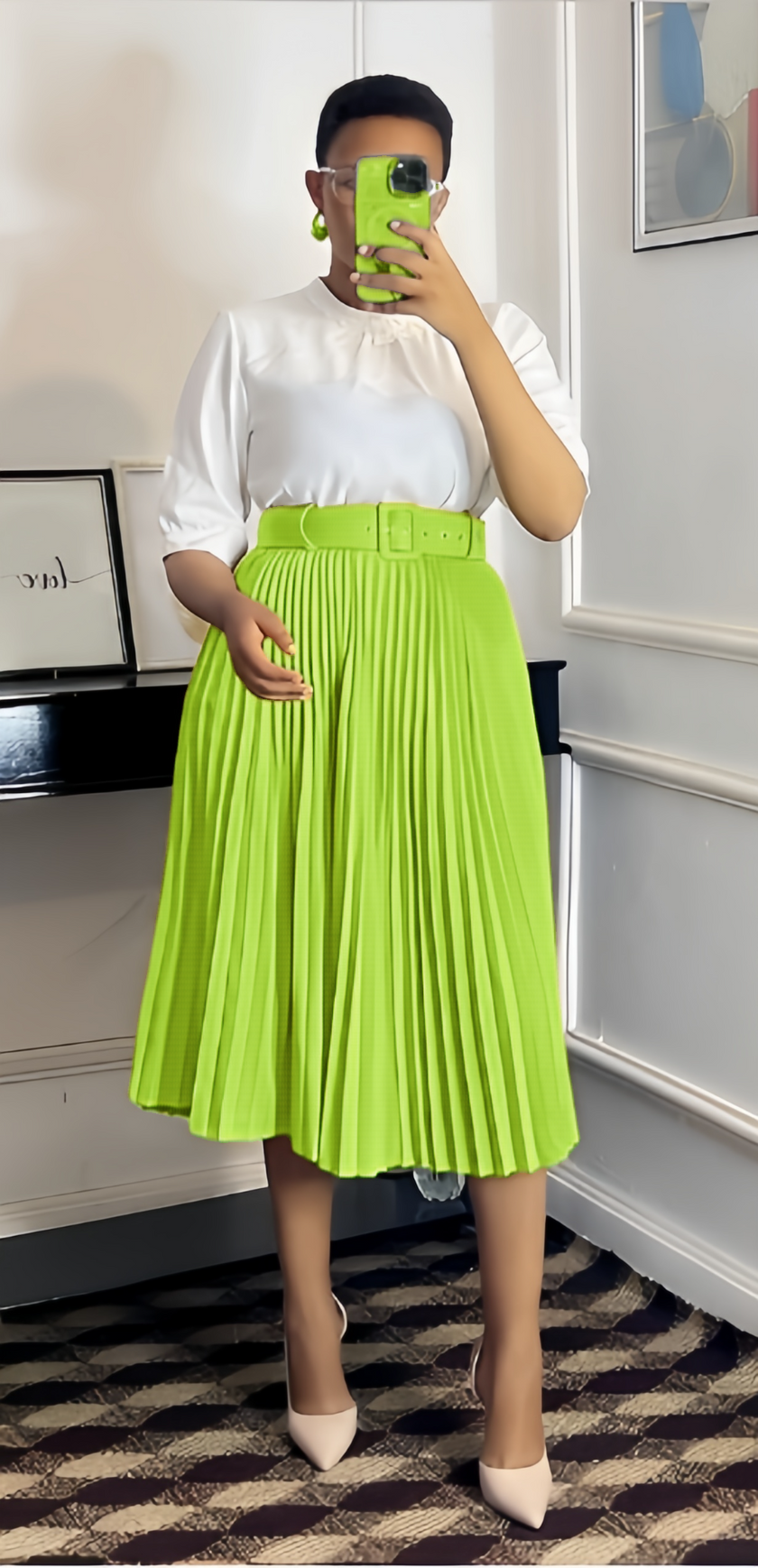 Bright green pleated midi A-line skirt with wide belt waistband.
