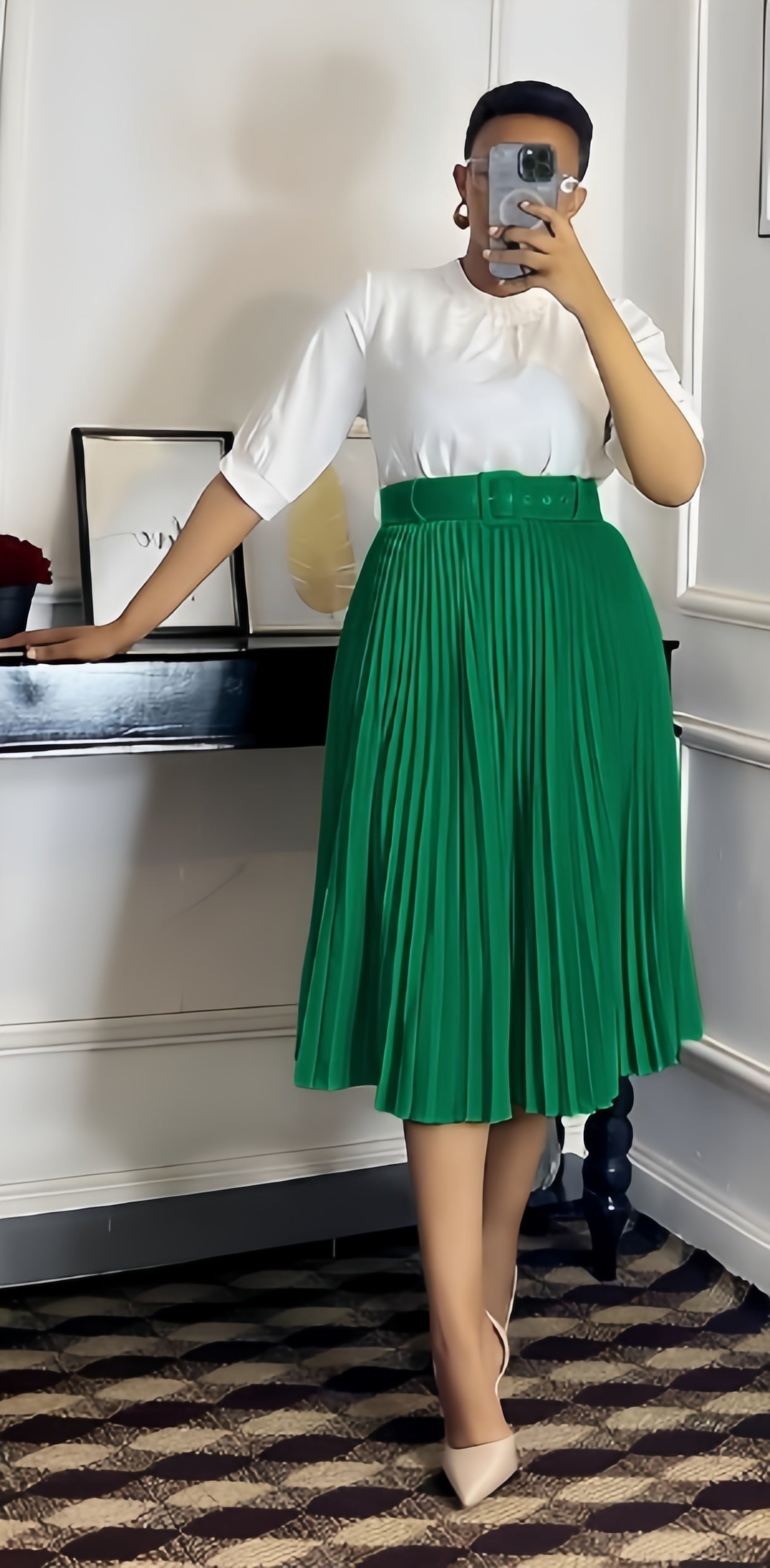 Dark green pleated midi A-line skirt with wide belt waistband.