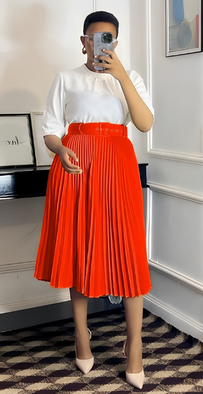 Red pleated midi A-line skirt with wide belt waistband.