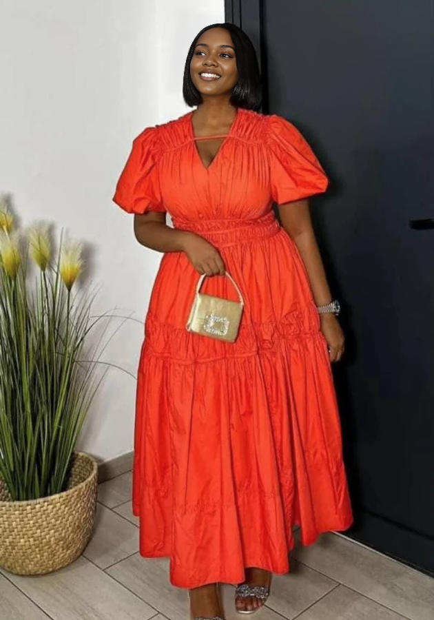 Orange-red tiered maxi dress with puff sleeves and V-neck, gathered waist