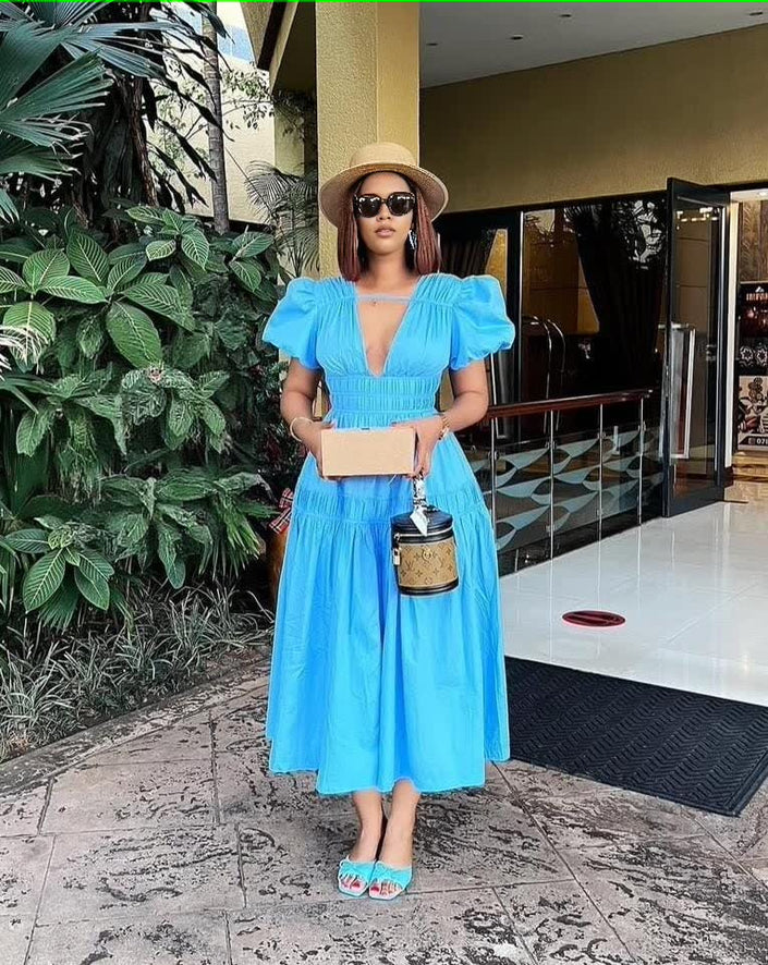 Sky-blue tiered maxi dress with puff sleeves and V-neck, gathered waist