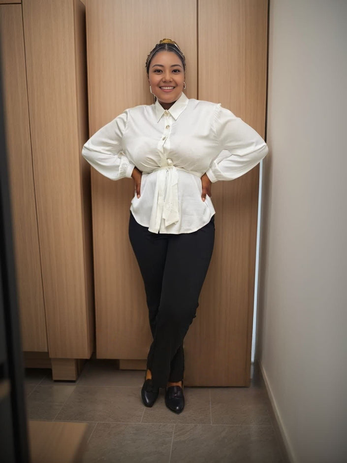 White long-sleeve blouse with bow tie neckline and button front